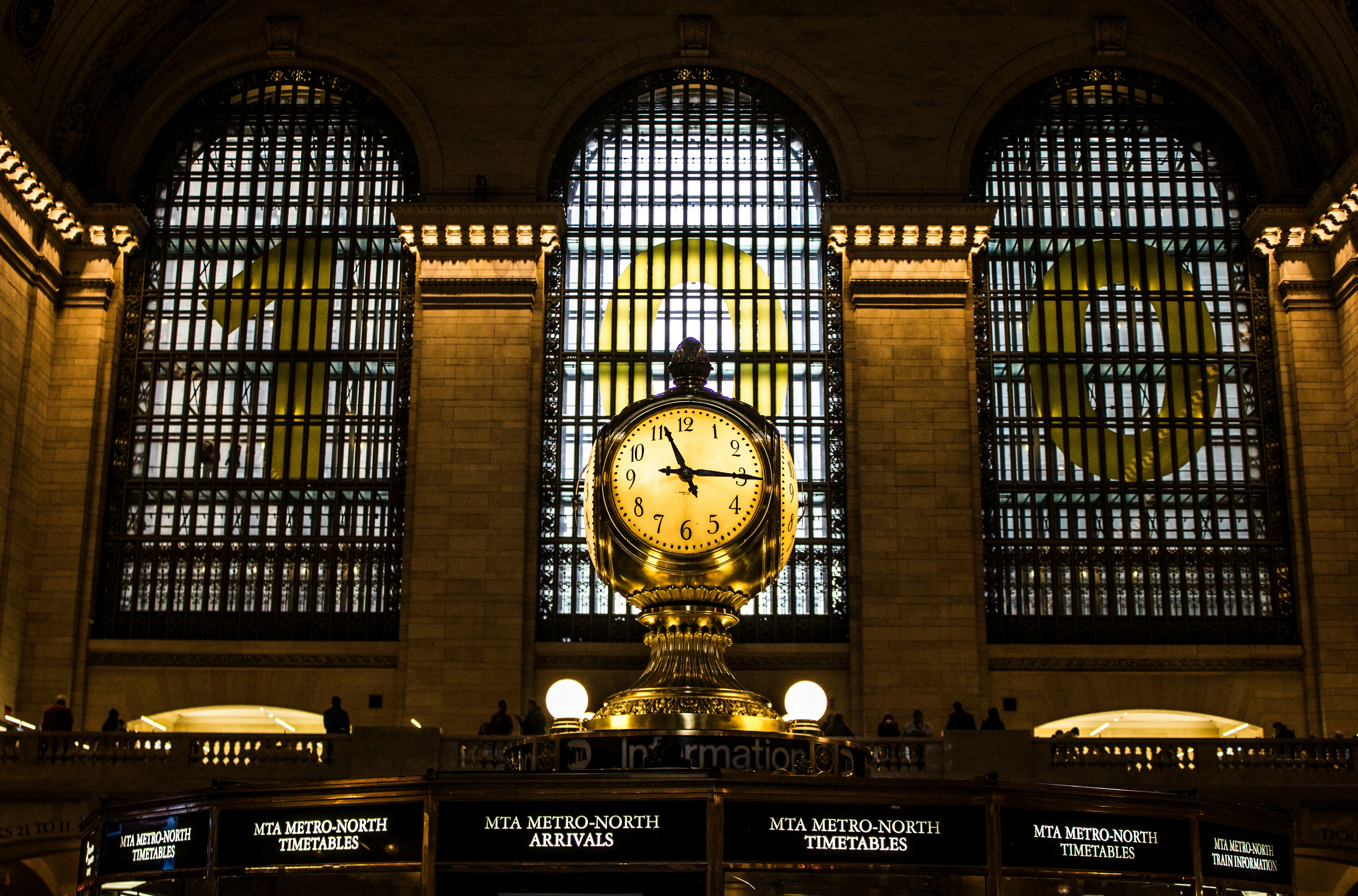 gold clock with time of 11:15